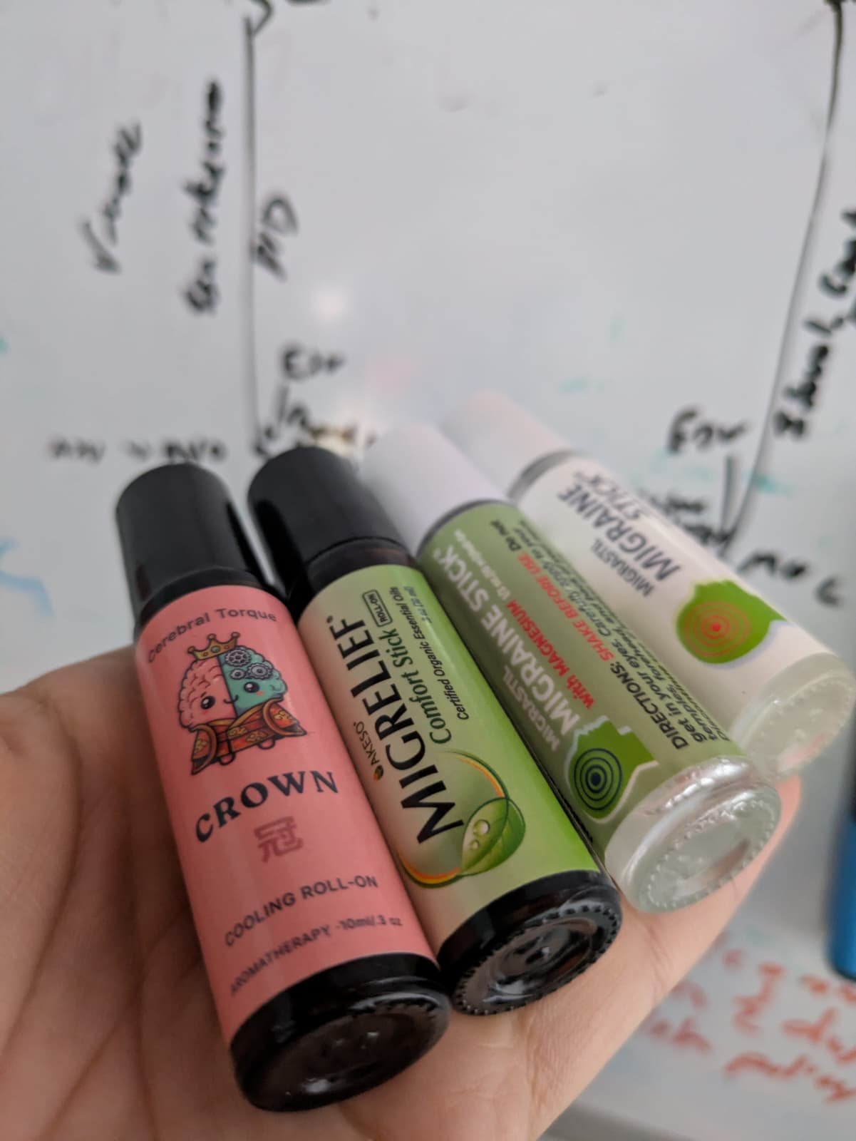 CROWN cooling migraine roller by Cerebral Torque next to Migrastil Migraine Stick, Migrastil with Magnesium, and MigreLief Comfort Stick