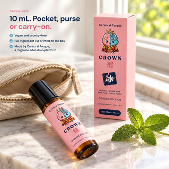 CROWN 10 mL travel-size roll-on and box on a sunlit marble vanity with a linen pouch and mint. Vegan and cruelty-free, made by Cerebral Torque