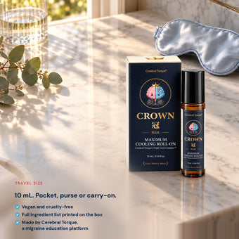 CROWN Plus 10 mL travel-size roll-on and box on a sunlit marble vanity, vegan and cruelty-free, made by Cerebral Torque
